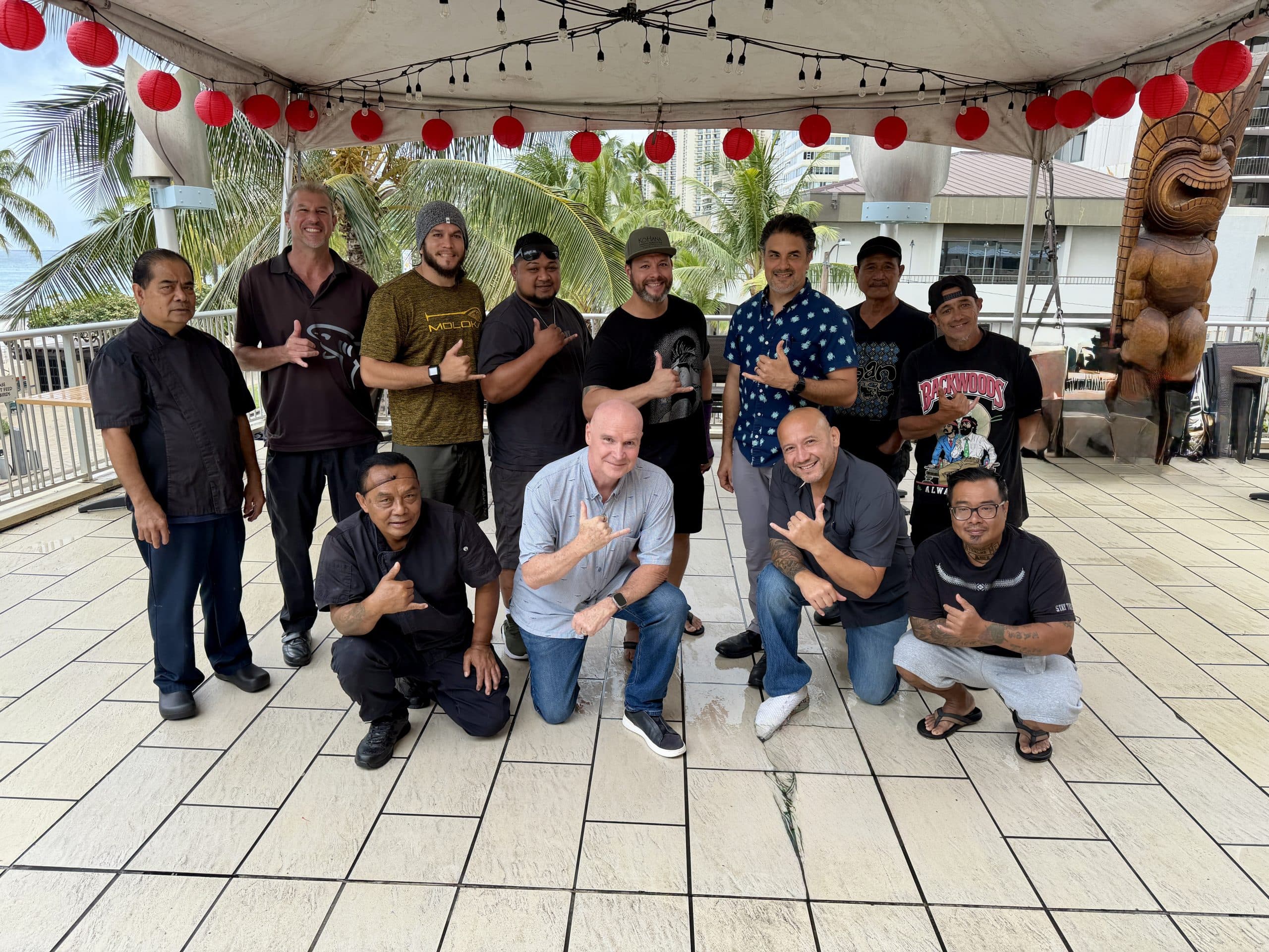 The fathers of Tiki’s Grill & Bar smiling together in Waikiki for Father’s Day