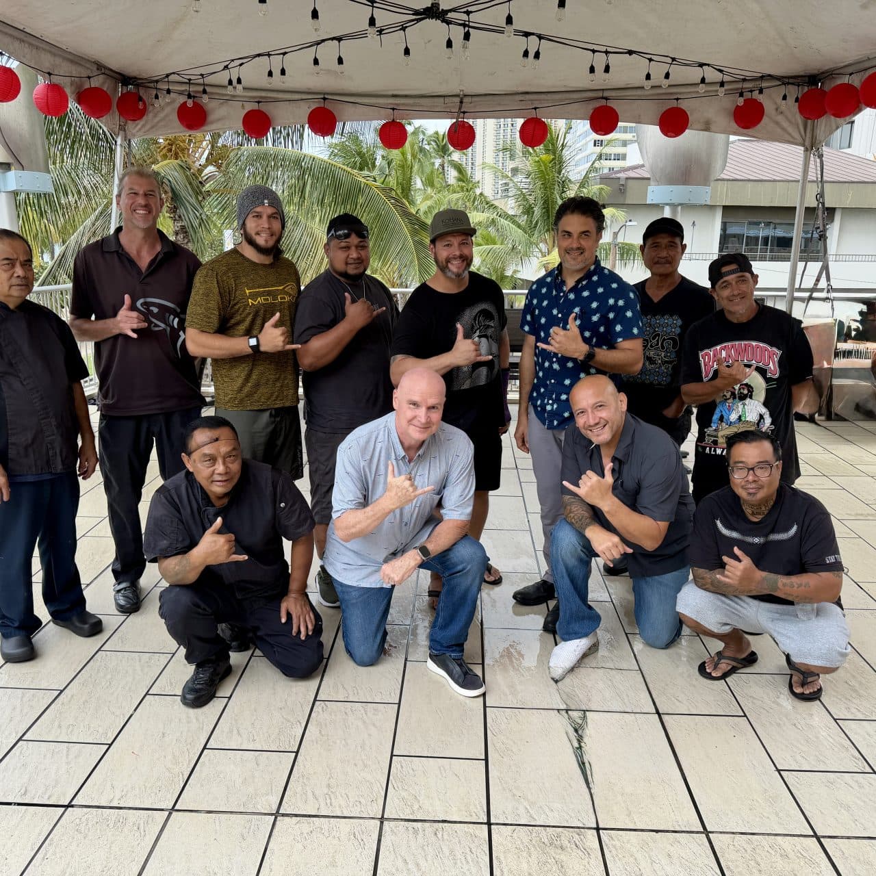 The fathers of Tiki’s Grill & Bar smiling together in Waikiki for Father’s Day